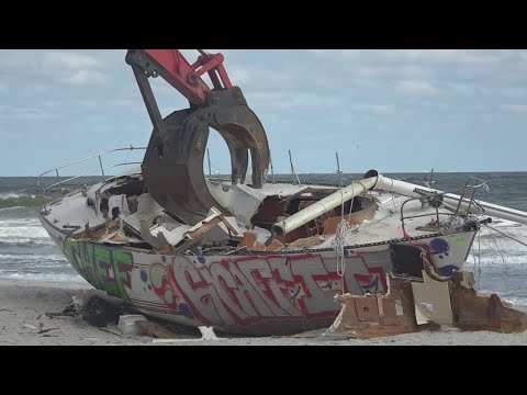 'It's sort of sad' | Sailboat marooned on Jacksonville Beach for months demolished by Salonen Marine